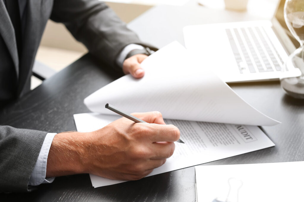 Photo of Businessman at desk working with documents